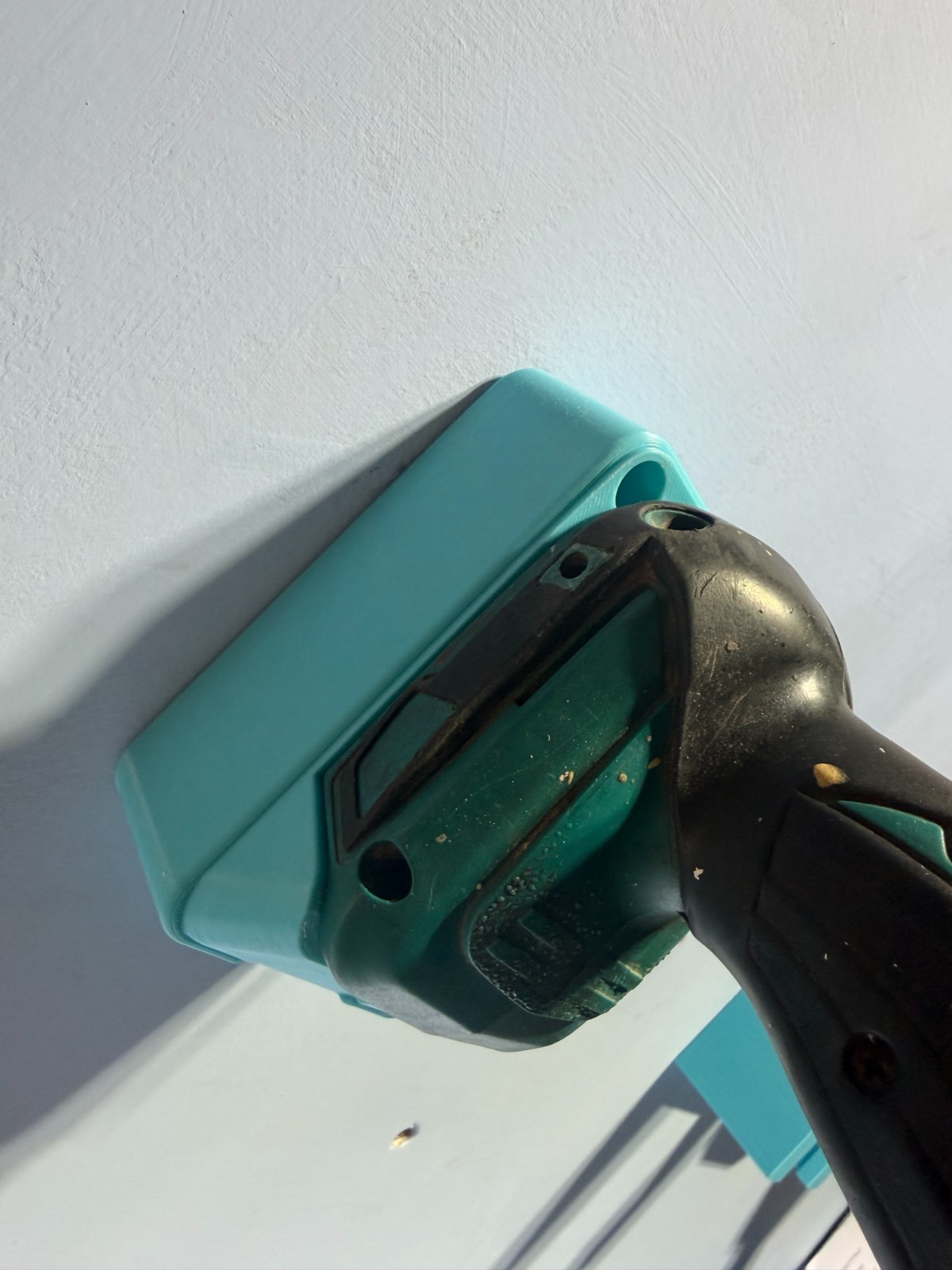 Garage Tool Storage Ideas: Walls, Drawers and Batteries 1 Close-up of a compatible Makita tool body seated in a blue wall holder